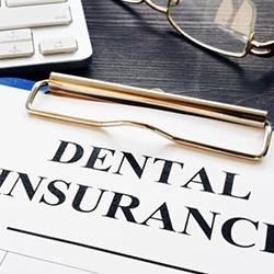 a dental insurance form next to a keyboard